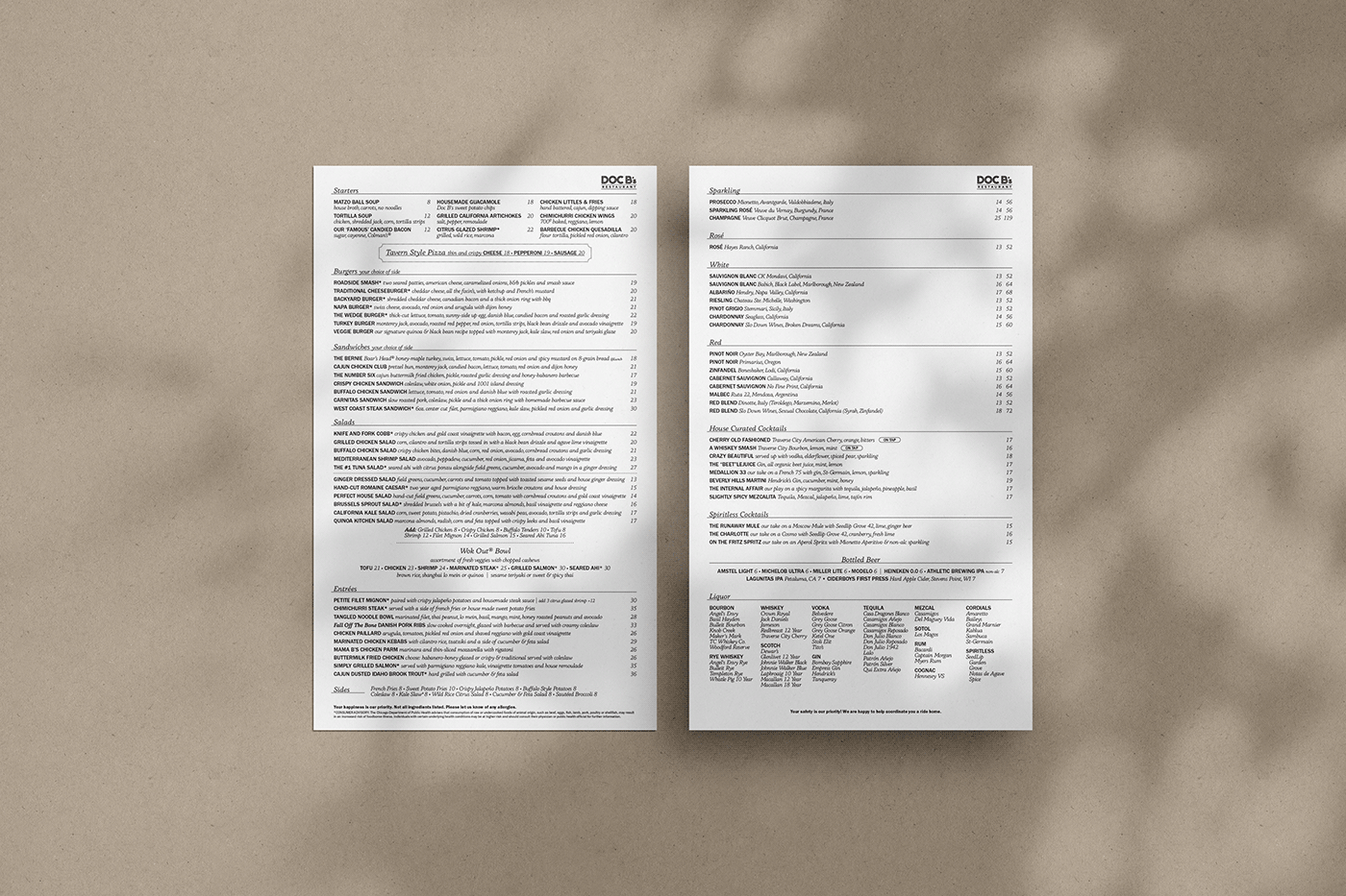 Doc B's food and beverage menus arranged on a warm textured surface.